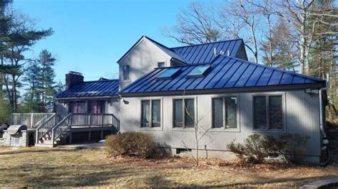 dark blue house cedar post dark metal roof|blue metal roof interior.